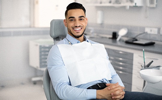 Patient smiling while sitting in treatment chair
